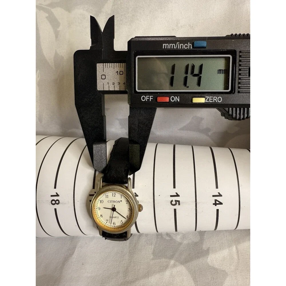 Citron Vintage Women’s Watch, White dial and gold casing. Black leather band.